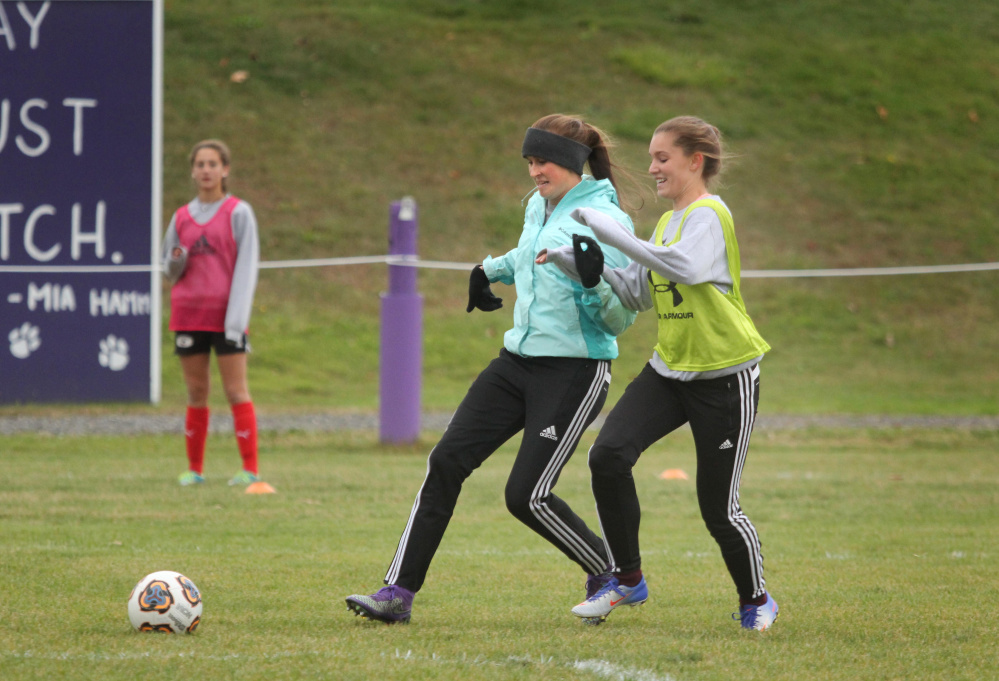 Waterville forward Sophie Webb and Sophie Anich, right, battle for the ball during practice on Monday.