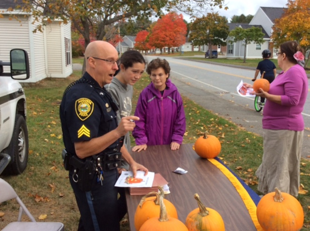 Sgt. Christian Behr keeps track of each Operation Pumpkin contest drawing submitted by Glenridge Drive school-age children in Augusta.