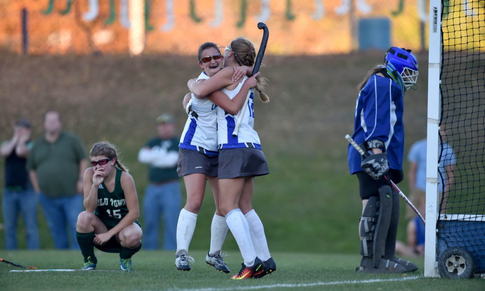 Lawrence sophomore Nora Buck, right, celebrates with Macie Larouche after Larouche scored in double overtime of a Class B North quarterfinal game against Old Town in Fairfield.