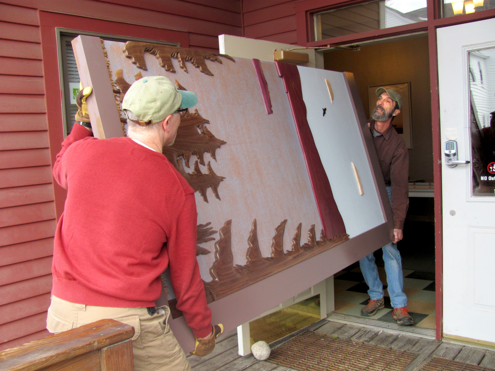 Artist Vincent Richel, right, and volunteer Jeff Zapolsky, left, carry one half of the functional art barn-doors that Richel created for the New Lobby Gallery at the RFA Lakeside Theater. The doors were commissioned by the Rangeley Friends of the Arts and provided for by generous donations.