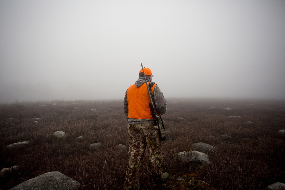 John Vogt Jr., of Oakland, makes his way through dense fog on Nov. 12, 2014, in a blueberry field in New Sharon back toward his truck while hunting moose with his father, John Vogt, of Belgrade. Of the roughly 181,000 people who hunt in Maine each year, about 40,000 come from out of state, spending $102 million on trip-related expenses, according to state data from 2011.