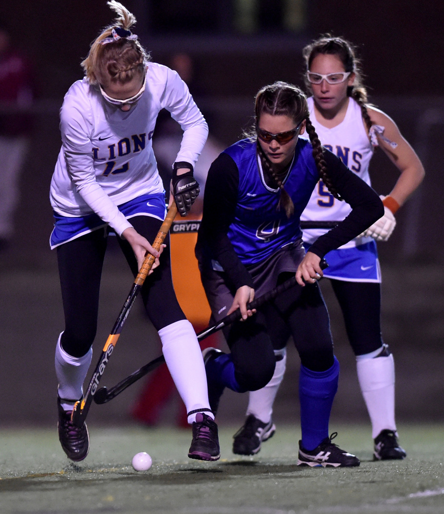 Belfast's Sabrina Wood, left, battles for the ball with Lawrence's Alexis Lewis  during the Class B North final Wednesday night Hampden Academy.