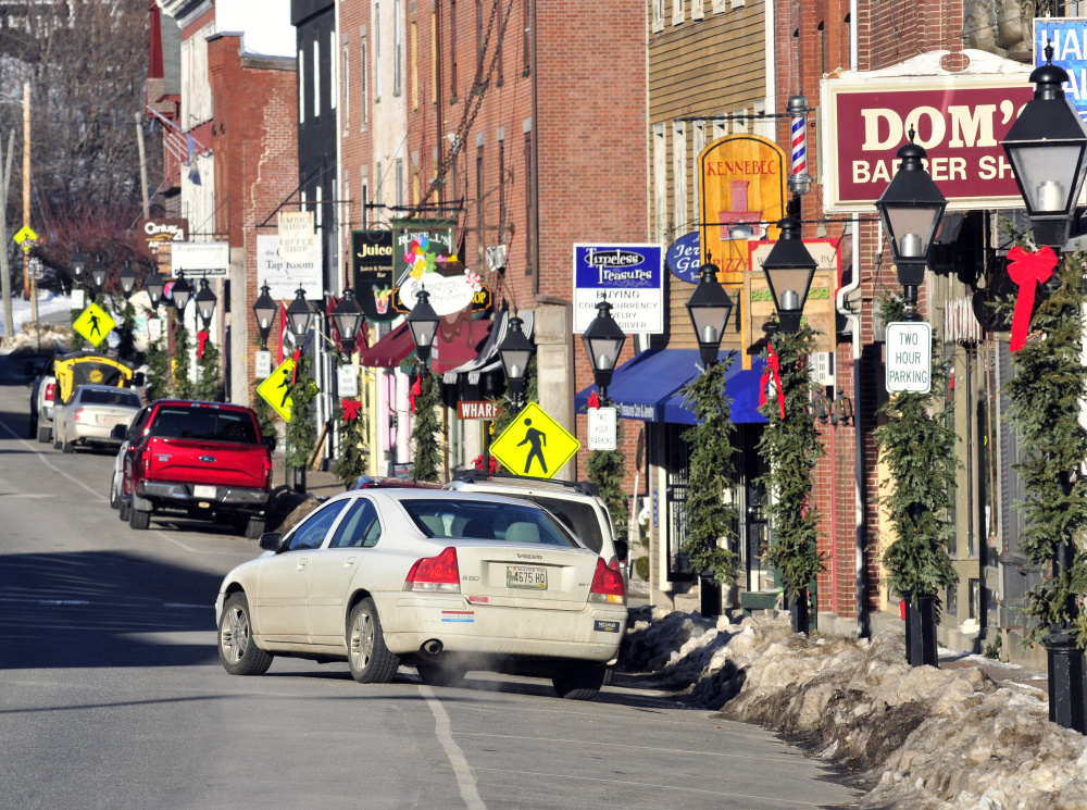 This Jan. 5 photo shows a car leaving a parking spot along Water Street in Hallowell, where the state transportation department is planning a major road reconstruction project in 2018.