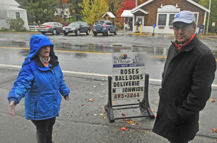 Jan Partridge, left, and Patrick Donahue talk Friday about a proposed crosswalk that will be located between Partridge's businesses, Balloons & Things and Pincurl Beauty Shop, and the Maine Lakes Resource Center Annex, where Donahue works, in Belgrade Lakes village.