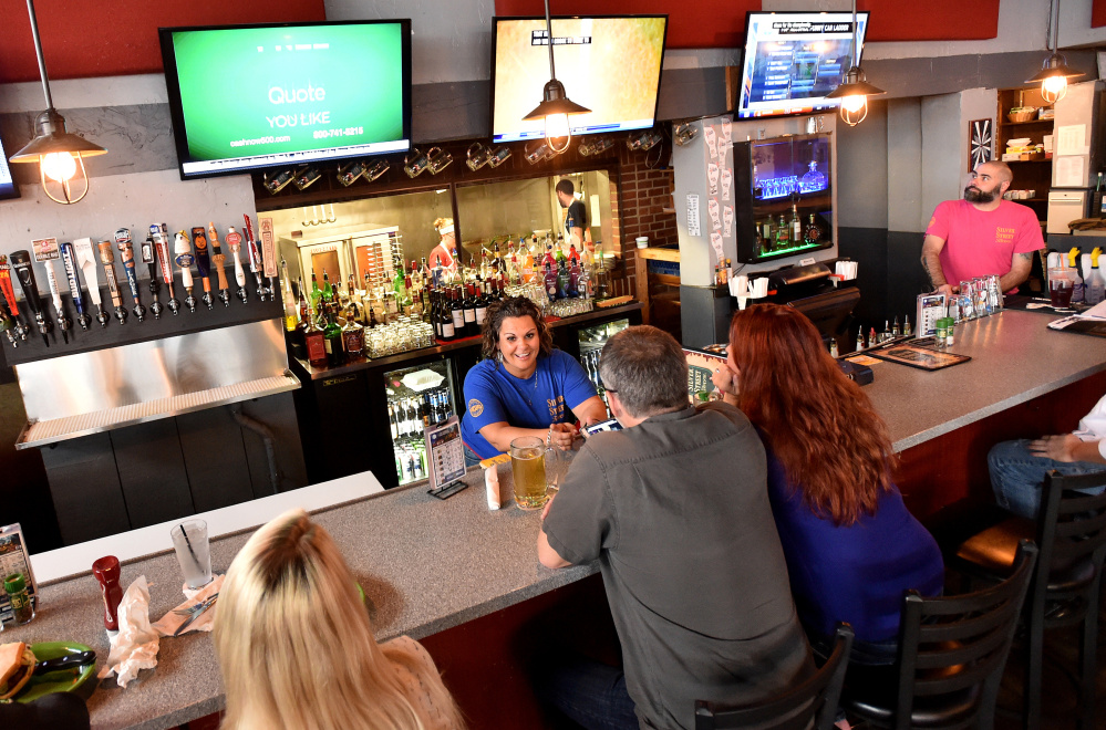 Andrea Shorty takes orders at the bar during her shift Friday at the Silver Street Tavern in Waterville.