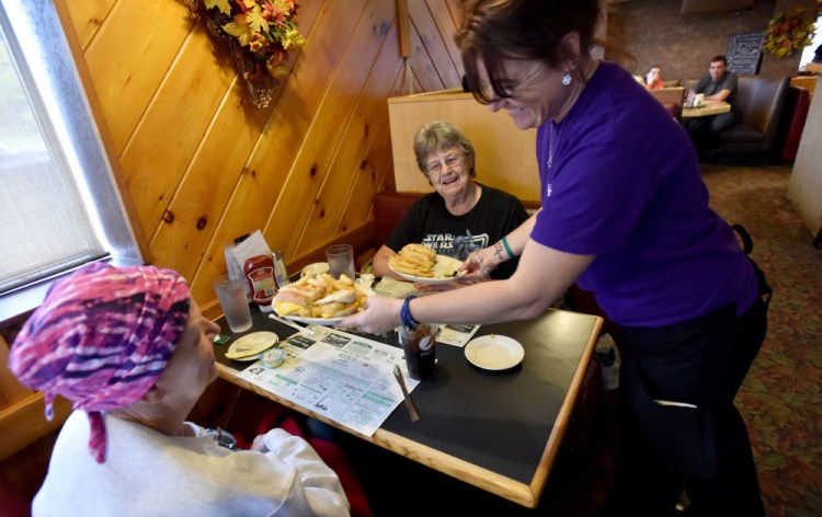 Tammie Webber, right, delivers hot food to Janice Beane, left, and her mother, Orlene Beane, center, both of Bingham, on Oct. 20 at Ken's Family Diner in Skowhegan.