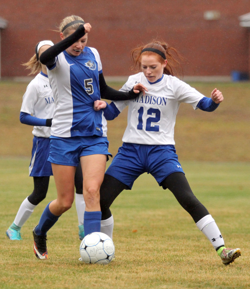 Madison's Ashley Emery tries to take the ball from Sacopee's McKenzie Murphy in the first half of a Class C South girls soccer semifinal in Madison on Saturday. Madison won 1-0.