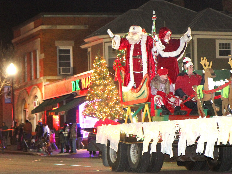 Santa and Mrs. Claus wave to the crowd during the eighth annual Parade of Lights and opening of Kringleville on Nov. 29, 2013, in downtown Waterville.