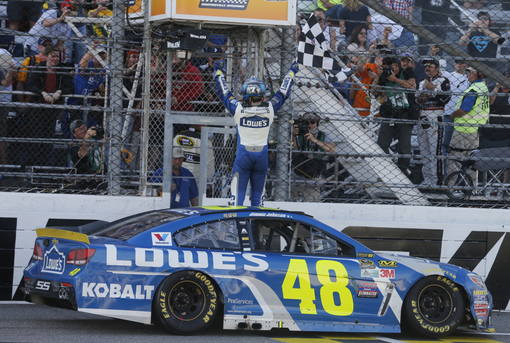 Jimmie Johnson celebrates after winning the NASCAR Sprint Cup Series race Sunday at Martinsville Speedway in Martinsville, Virginia.