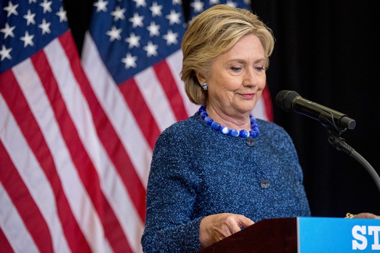 Hillary Clinton pauses while speaking at a news conference in Des Moines, Iowa, on Friday after the FBI announced that it is investigating whether new emails involving the Democratic presidential nominee contain classified information.