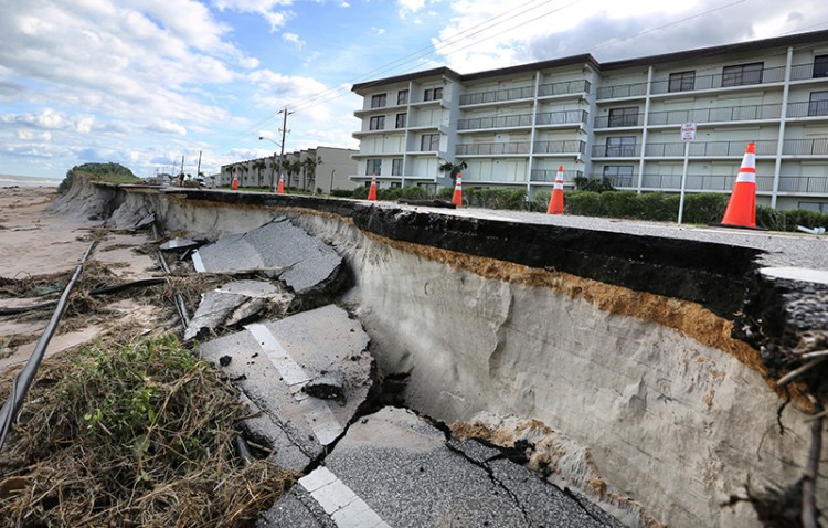 Erosion caused by high surf from Hurricane Matthew takes a chunk of the beachside-road in Ormond-By-The-Sea, Fla.