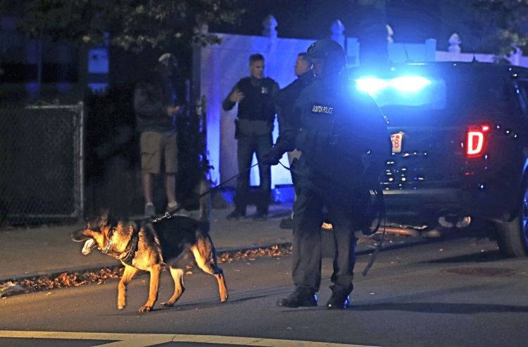 Police patrol an East Boston neighborhood after a shooting late Wednesday. <em>Charles Krupa/Associated Press</em>