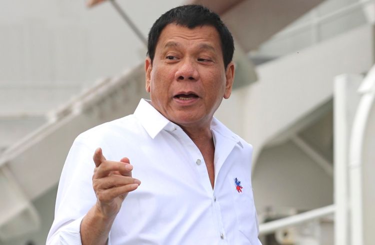 Philippine President Rodrigo Duterte, on returning from a three-day visit to Japan, tells supporters "I promise God to ... not express slang, cuss words and everything.
<em>Associated Press/Eugene Hoshiko</em>


