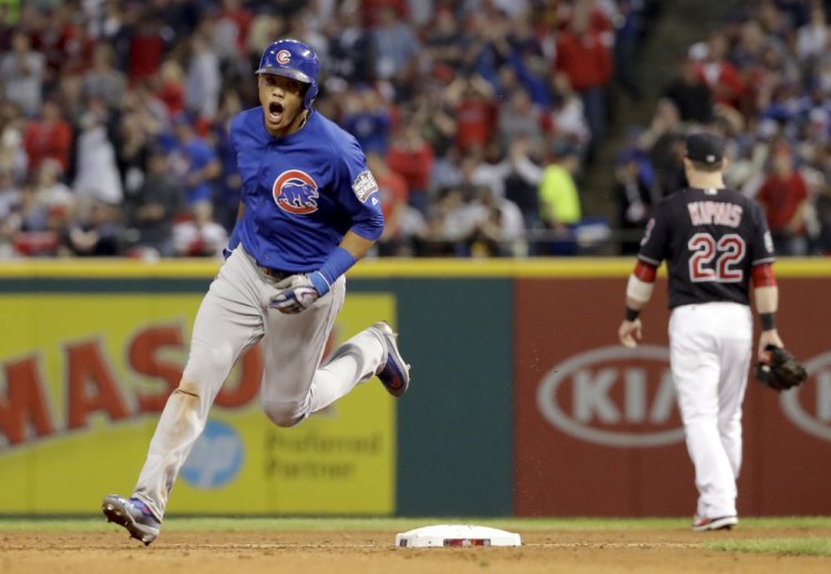 The Cubs' Addison Russell celebrates his grand slam home run in the third inning of Game 6 on Tuesday night in Cleveland. Russell provided the offensive power in the Cubs' series-evening win over the Indians.