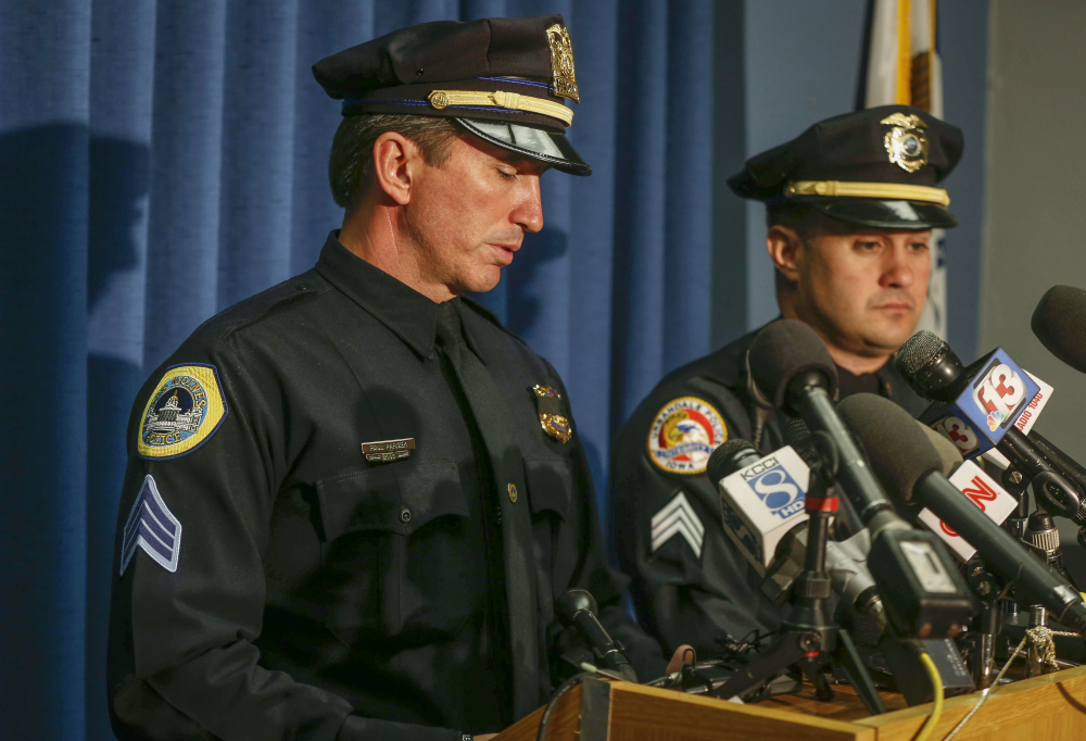 Des Moines Police Sgt. Paul Parizek, left, pauses to fights back emotions as he speaks to media during a news conference Thursday at the Des Moines Police Department in Des Moines, Iowa, regarding the fatal shooting of two officers.