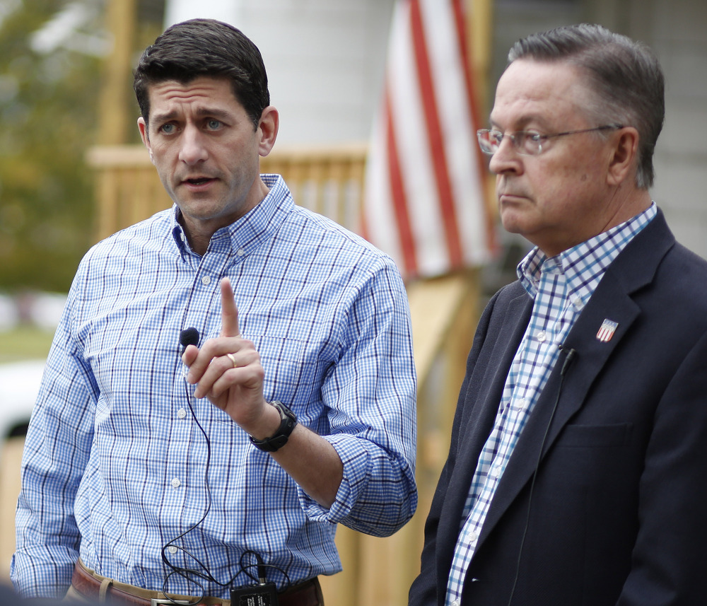 U.S. House Speaker Paul Ryan, left, talks with the media Wednesday with U.S. Rep. Rod Blum in Waterloo, Iowa.