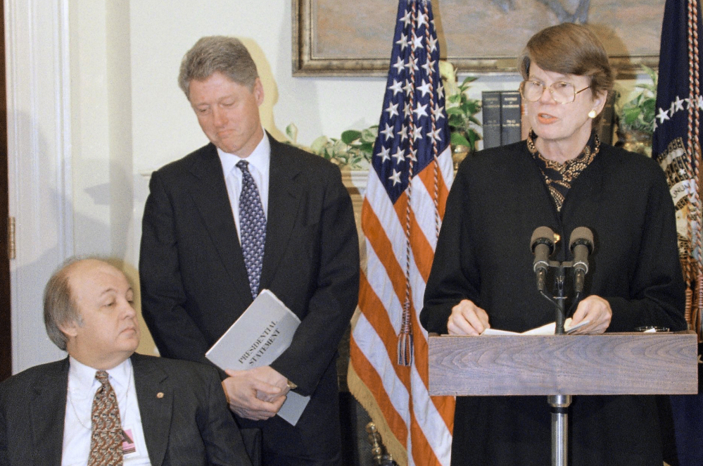 Attorney General Janet Reno, accompanied by President Bill Clinton and James Brady, speaks at a 1995 White House ceremony marking the one-year anniversary of the Brady handgun control law. Reno was the first woman to serve as U.S. attorney general.