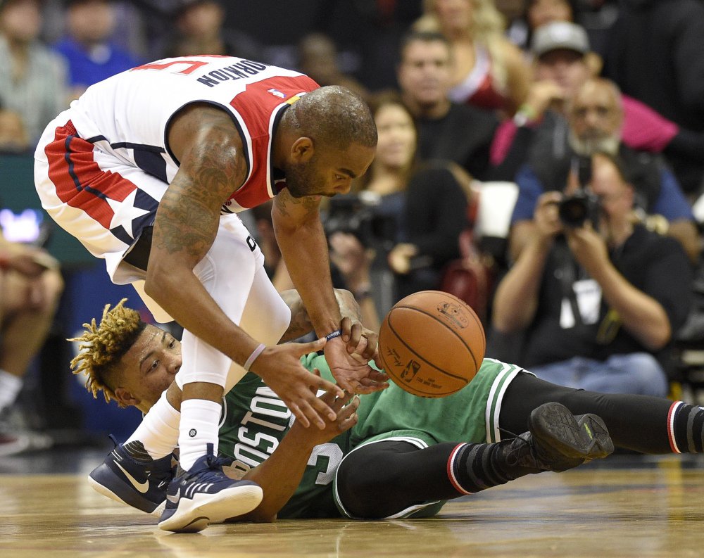 Boston's Marcus Smart, bottom, battles for the ball with Washington's Marcus Thornton in the first half Wednesday night in Washington.