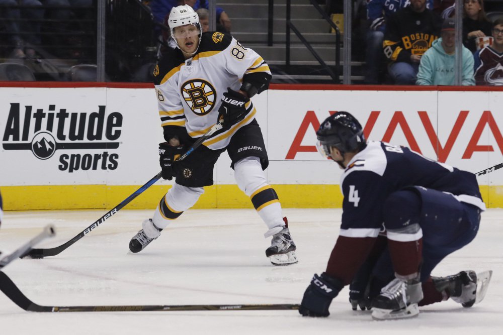 Bruins right wing David Pastrnak launches send a pass by Avalanche defenseman Tyson Barrie in the second period of Boston's 2-0 win Sunday in in Denver.