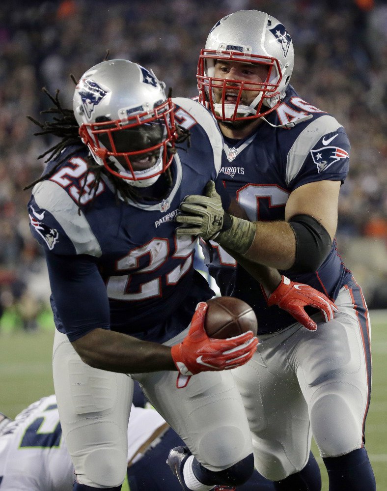 LeGarrette Blount celebrates one of his three touchdowns with fullback James Develin. Blount has 12 rushing touchdowns this season, two shy of Curtis Martin's team record.