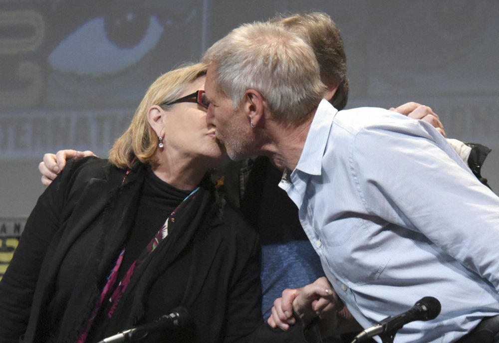 Carrie Fisher and Harrison Ford kiss at Comic-Con in San Diego, Calif., in 2016.