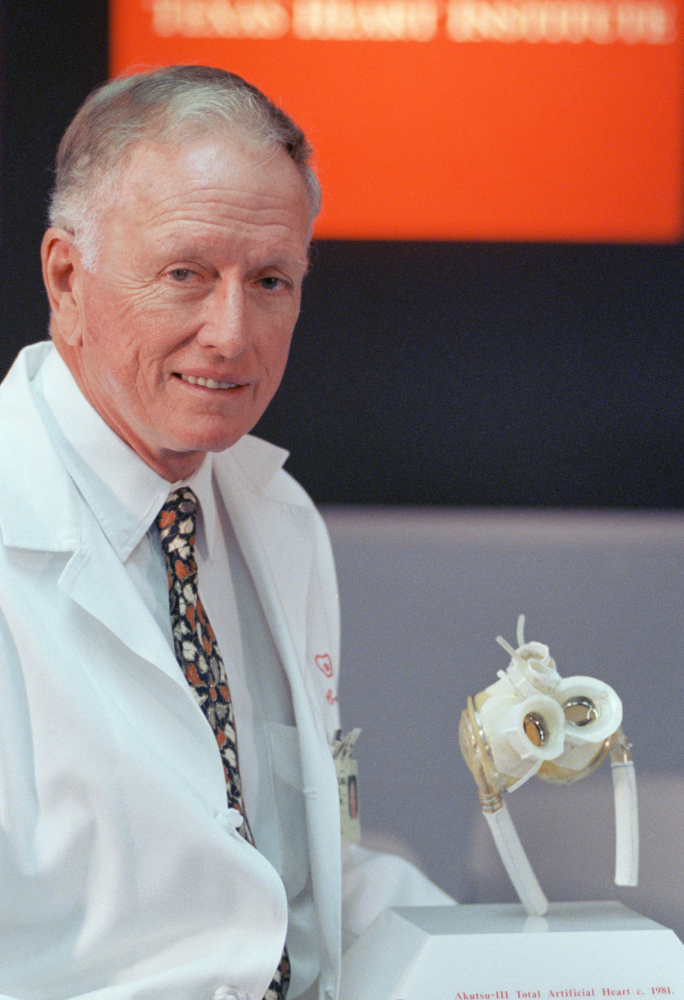 Denton Cooley holds an artificial heart in 1994. A leading practitioner of the coronary bypass, he was also renowned for correcting congenital heart problems in infants and children.