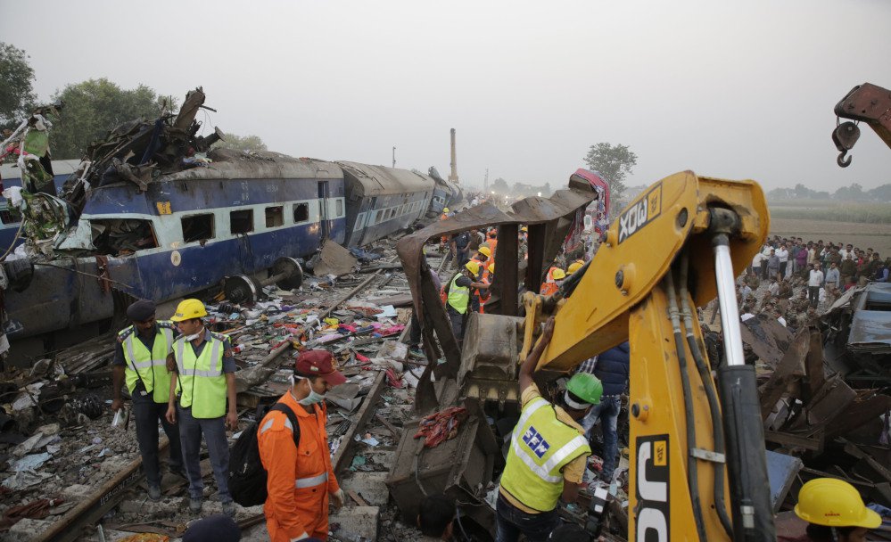 Rescuers use machinery to remove debris Sunday after 14 coaches of an overnight passenger train derailed near a village in northern India. The cause was not immediately clear. Accidents are relatively common on India's sprawling rail network.