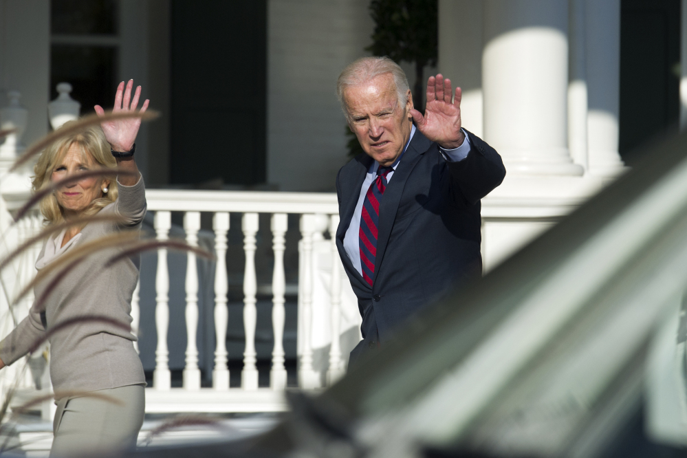 Vice President Joe Biden and Dr. Jill Biden wave after having lunch with Vice President-elect Mike Pence and his wife, Karen, at the Vice President's residence, the Naval Observatory, in Washington.