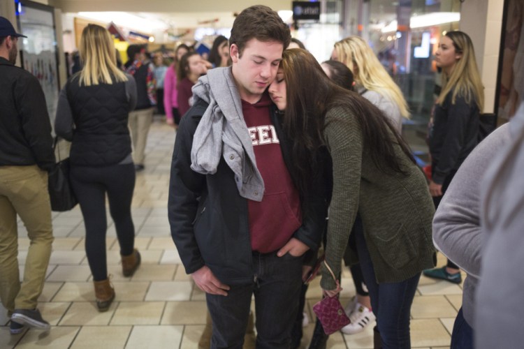 Max Richardson, 17, of Cumberland, and Trinity Turcotte, 16, of Brunswick, wait in line to get into the store Pink just after midnight at the Maine Mall.