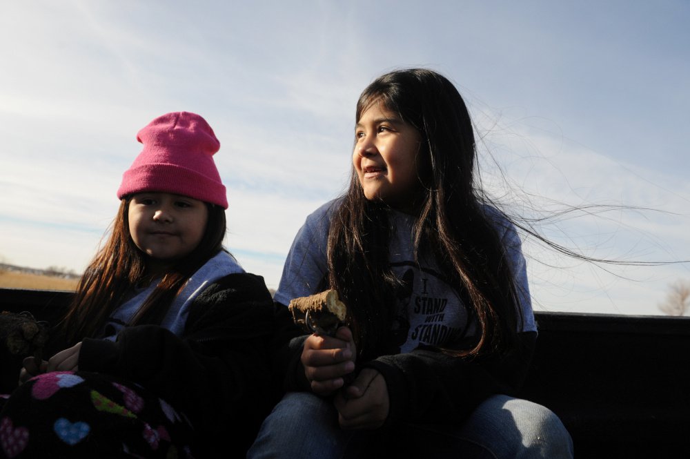 Girls from the Pomo tribe ride in the back of a truck during a protest Friday against Dakota Access pipeline plans.