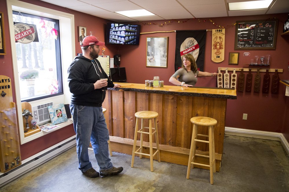 Peter Heggeman, head brewer at Geary's, and Danielle Coons, the tasting room ambassador, chat in Geary's tasting room. The brewery, which has been around since 1983, is Maine's oldest craft brewery.