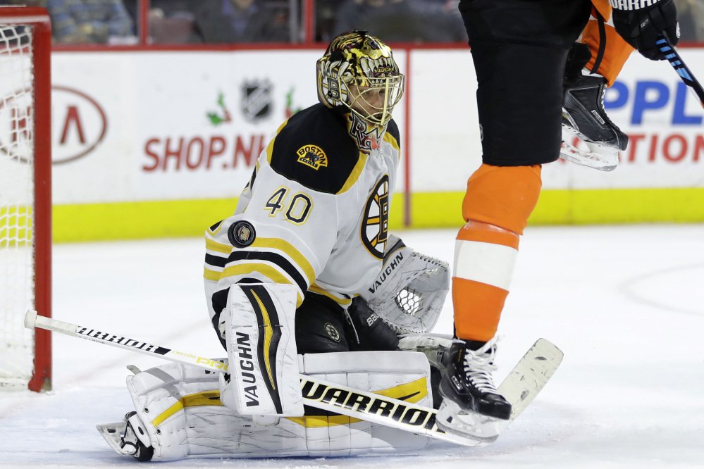 Bruins goalie Tuukka Rask blocks a shot as the Flyers' Wayne Simmonds tries to screen on a shot in the second period Tuesday night in Philadelphia.