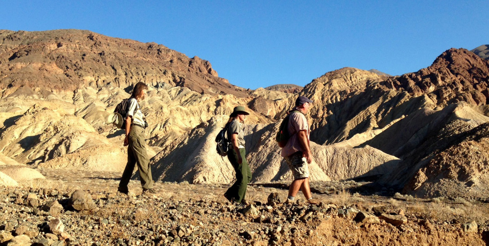 Naturalist Birgitta Jansen, from left, National Park Ranger Abby Wines and Loma Linda University paleontologist Torrey Nyborg following a trail that contains one of the largest concentrations of fossil tracks in the world.