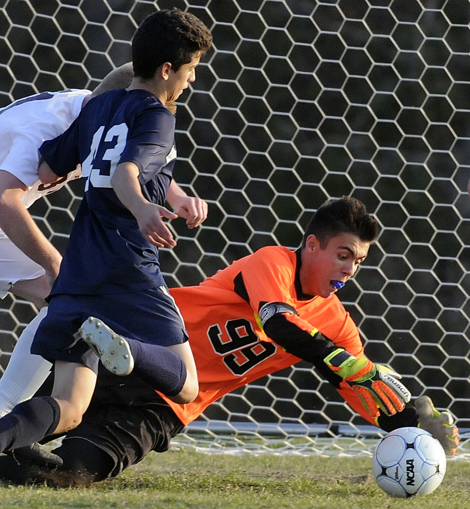 Richmond goalie Zach Small covers a shot from Greenville's Chris Caiazzo during the Class D South regional final Wednesday in Richmond.