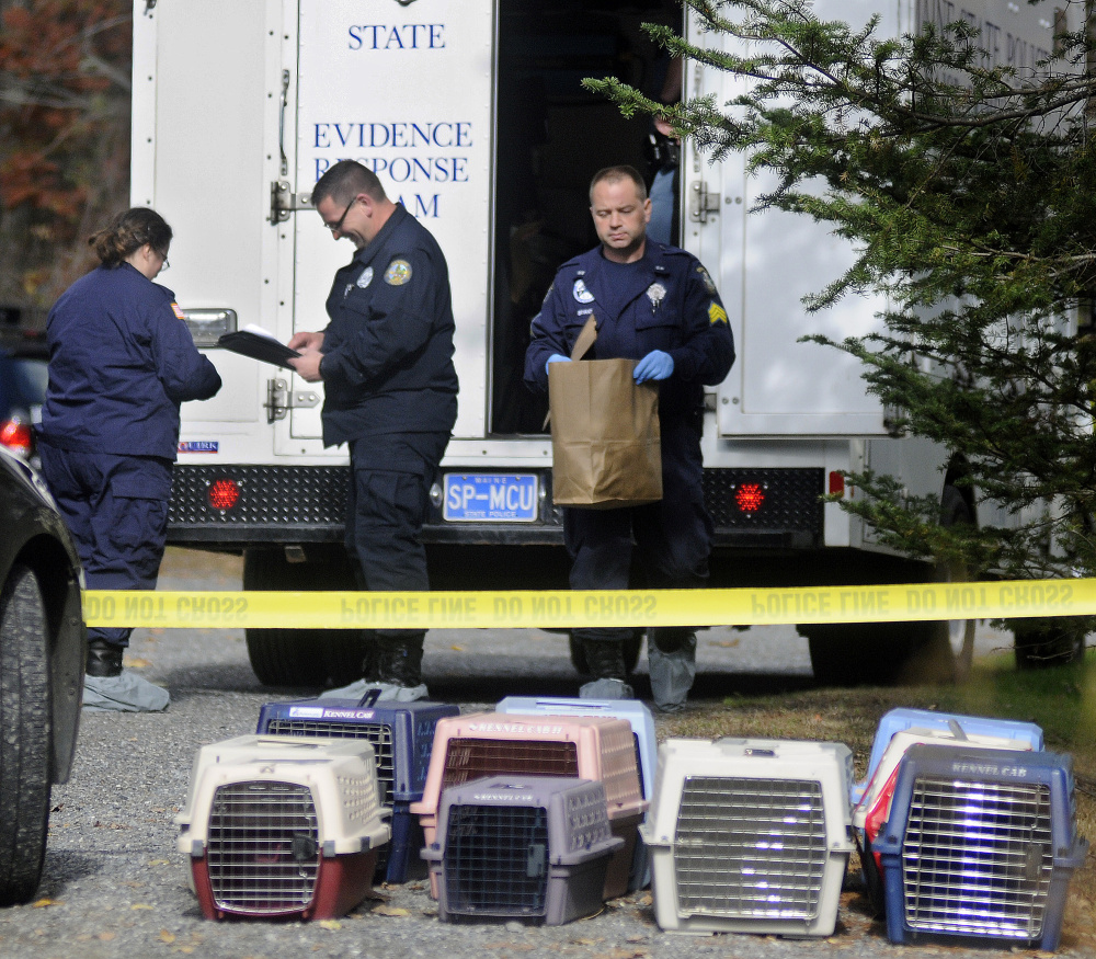 State police collect evidence Monday from the home in Winthrop where the bodies of Antonio and Alice Balcer, both 47, were found after an early morning 911 call. The Winthrop Veterinary Hospital, where Alice Balcer worked, is caring for pets removed from the home.