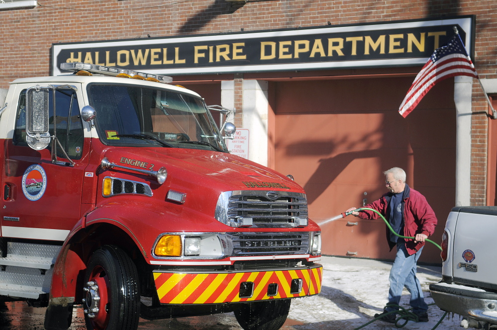 Richard Clark washes a Hallowell fire engine in 2015 at the city's station on Second Street. A committee is discussing whether to move the city's firetrucks and crew from the outdated fire station to a new location or partner with a surrounding community for fire protection services.