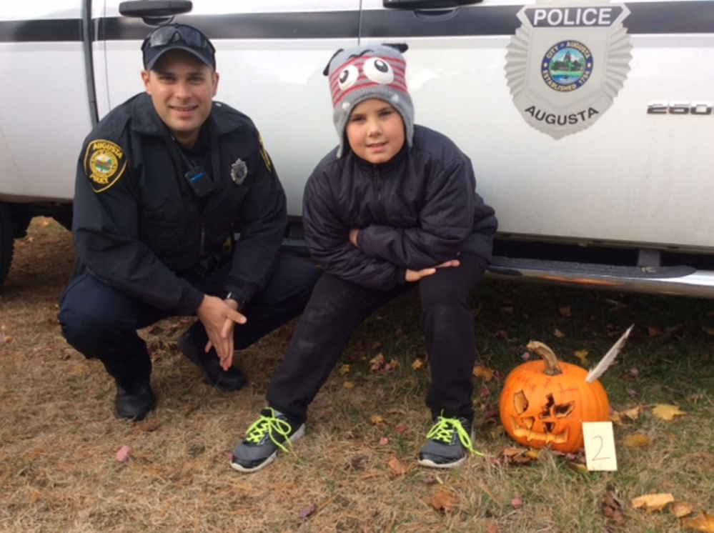 Noah Dow with pumpkin #2 with Officer Jonathan Provisor.