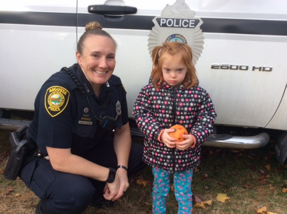 Iris Emond with pumpkin #3 with Officer Carly Wiggin.