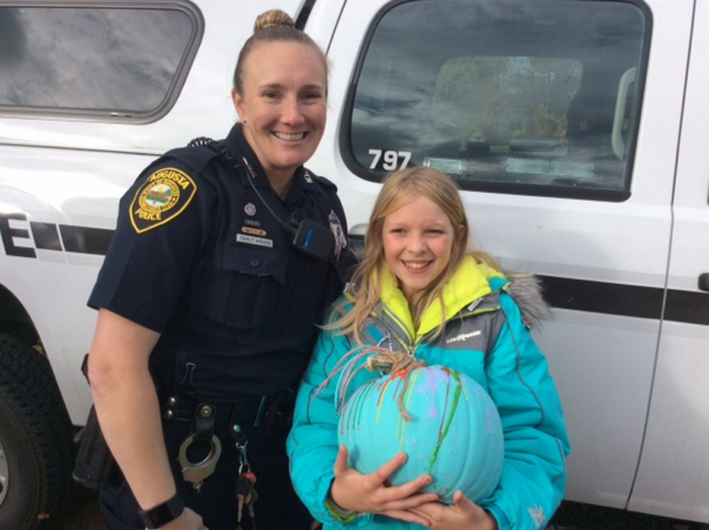 Ryleigh Miranda with pumpkin #6 with Officer Carly Wiggin.