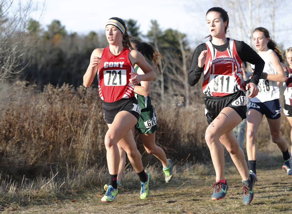 Cony's Anne Guadalupi, left, and Scarborough's Bethany Sholl, right, run during the Class A girls state championships Saturday in Belfast.