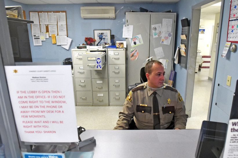 Deputy John Morris, with the Somerset County Sheriff's office, Madison Division, works the desk on Dec. 23, 2015. The Madison Police Department was absorbed by the Somerset County Sheriff's office in 2015, and the town has been reimbursed $79,500 because costs for running the new Madison division came in about 16 percent under budget in its first year.
