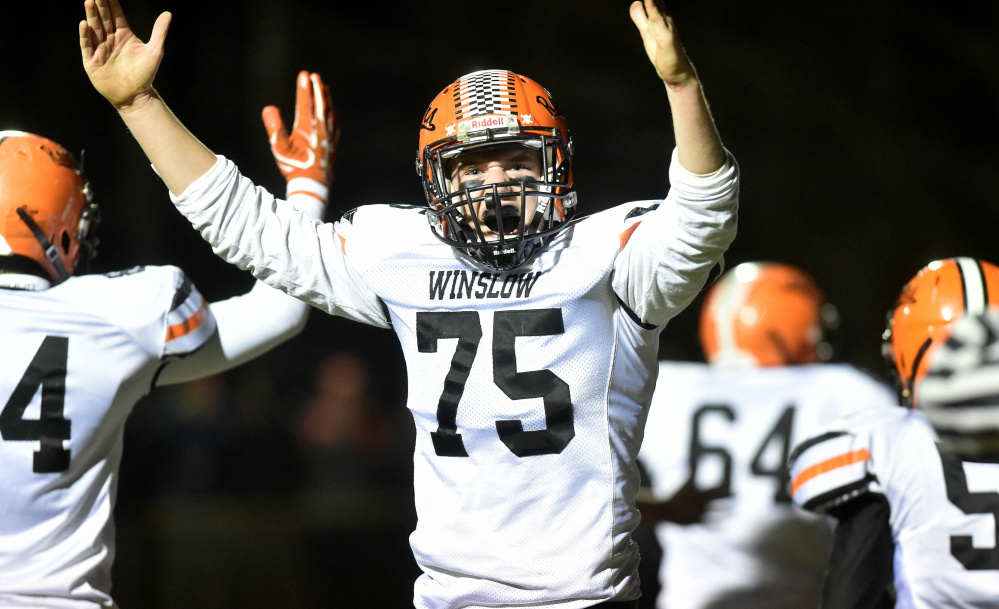 Winslow lineman Ben Abbott (75) celebrates a Ryan Gagnon quarterback sneak for a touchdown during a Big Ten Conference semifinal game Friday night at Rudman Field in Madison.