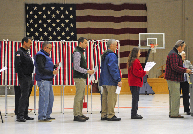 Voters wait in line to cast ballots around 7:10 a.m. Tuesday at the Ward 1 polling place in the Augusta State Armory.
