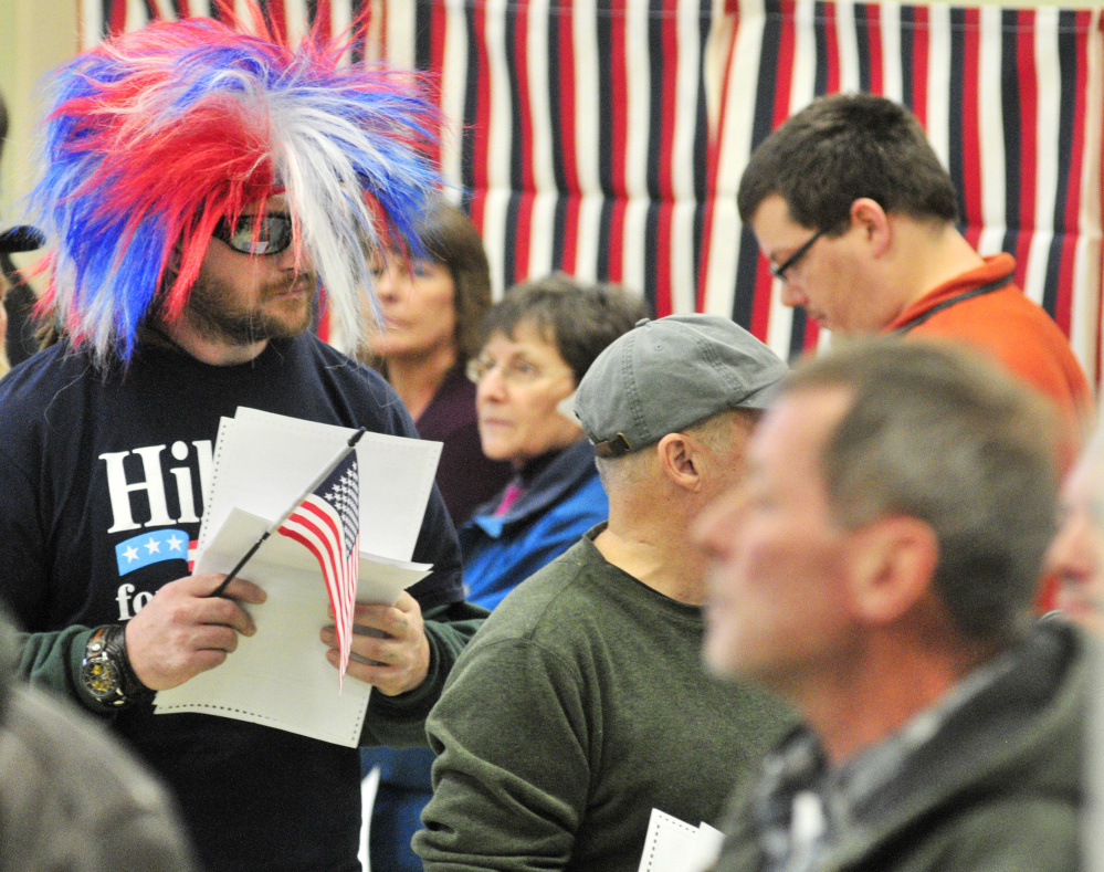 Israel Legassie waits in line to cast his ballot Tuesday while wearing a Hillary for Prison shirt and a red, white and blue wig at the Boys and Girls Club of Greater Gardiner.
