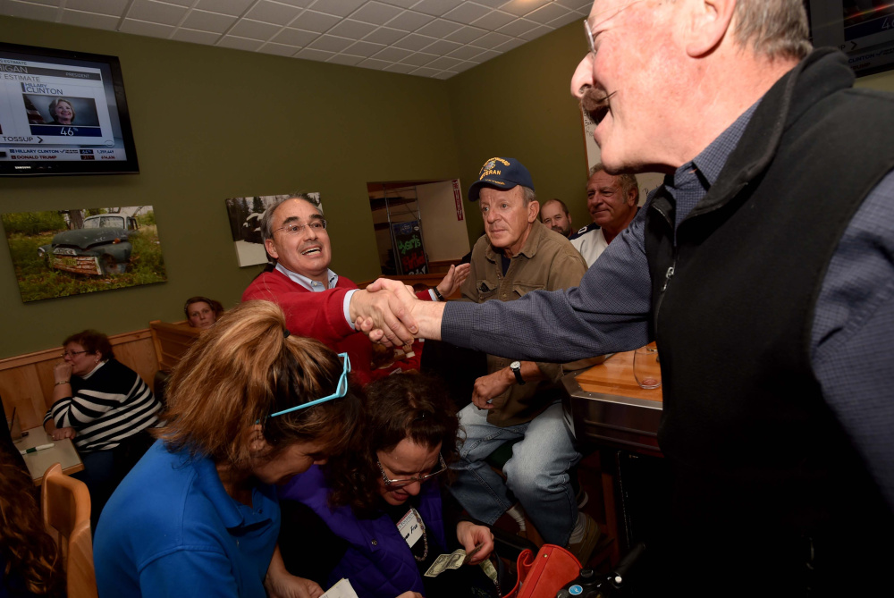 U.S. Rep. Bruce Poliquin visits with supporters at Dysart's Restaurant and Bakery in Bangor after the polls closed on Tuesday.