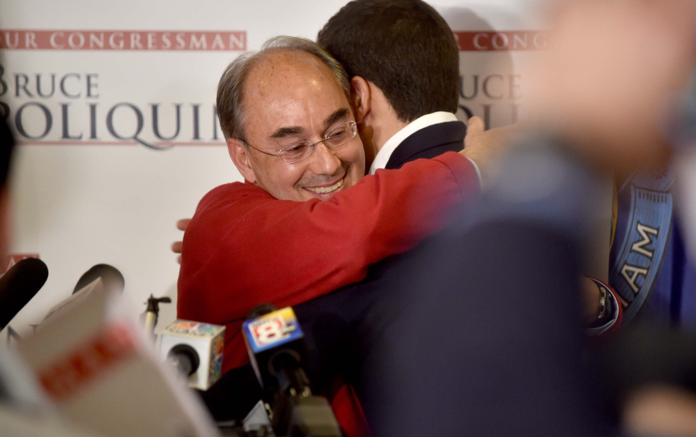 U.S. Rep. Bruce Poliquin hugs his son, Sam, at Dysart's Restaurant and Bakery in Bangor after beating Emily Cain in the 2nd District race on Tuesday.