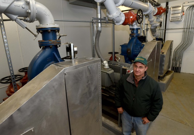Boyd Snowden, superintendent of the Oakland Sewer District, poses Thursday next to sewer pumps at the town's Sewer Department.