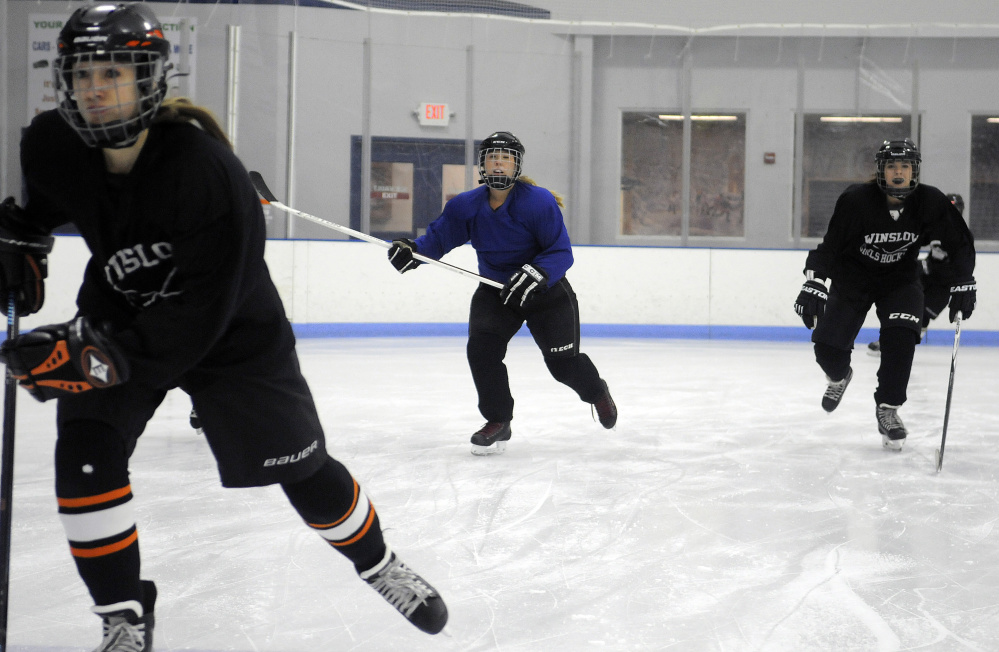 Members of the Winslow/Gardiner girls hockey team skate during practice last Wednesday at the Ice Vault in Hallowell.