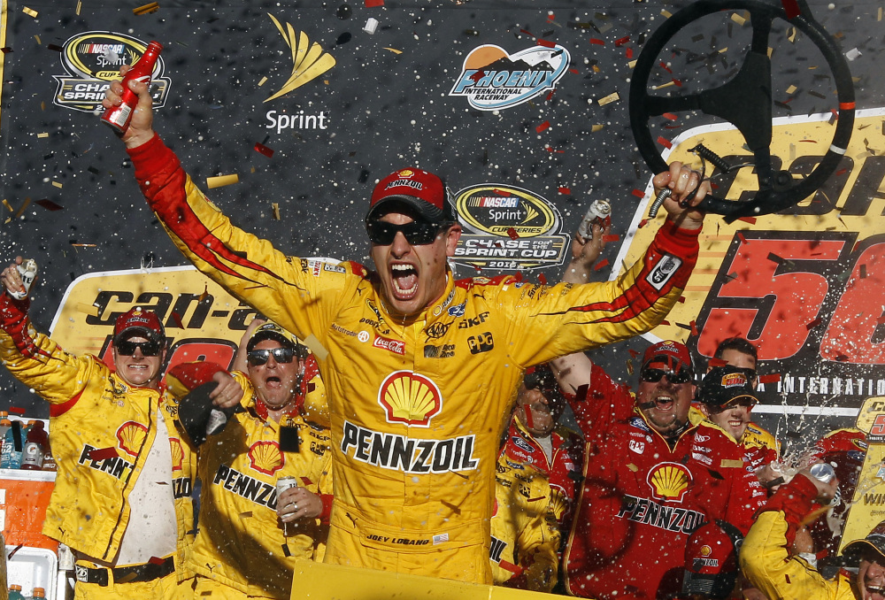 Joey Logano celebrates in the victory lane after winning the NASCAR Sprint Cup Series race on Sunday at Phoenix International Raceway in Avondale, Arizona.