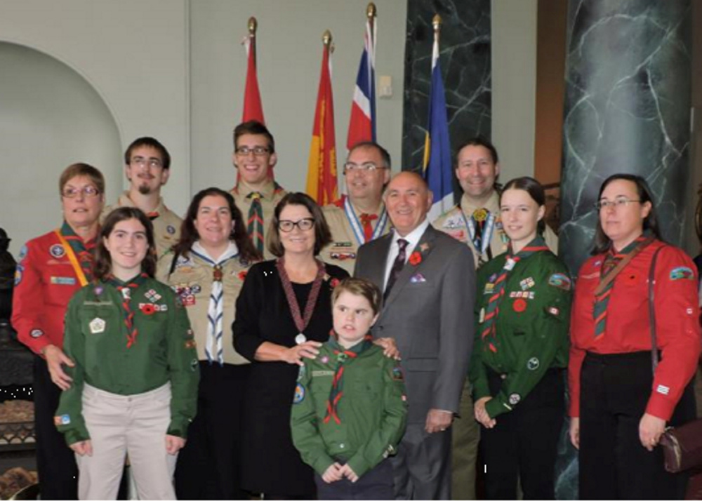 In front is Evan Hardt (1st ketepec). Middle row, from left, is Paige Spears, Yvette Bernier (T433), Lieutenant-Governor of New Brunswick the honorable Jocelyne Roy Vienneau, Ron Vienneau, Emily Hardt (1st Ketepec and Chief Scout), and Julia Chesley (1st Ketepec). In back, from left, is Brenda Graham (Scoutmaster 1st Ketepec) Adam Hutchinson (T433), Holden Cookson (T433), Scott Bernier (KV District), and Chris Bernier (T433).